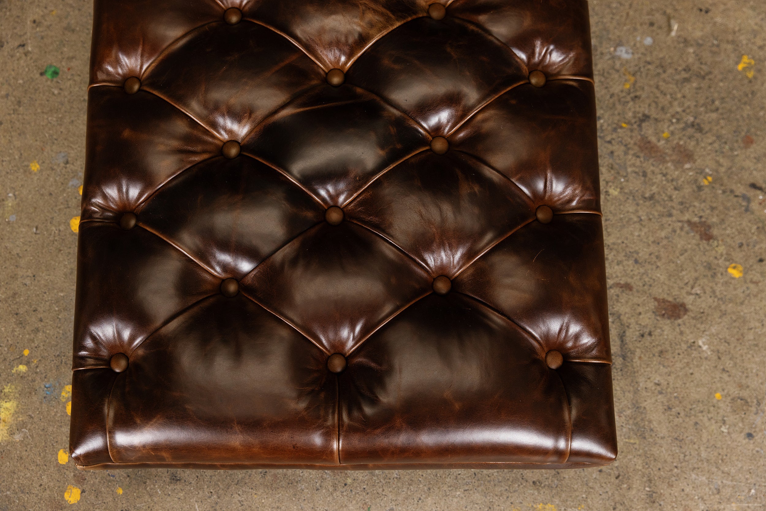 PERCY LEATHER CASTER TUFTED OTTOMAN